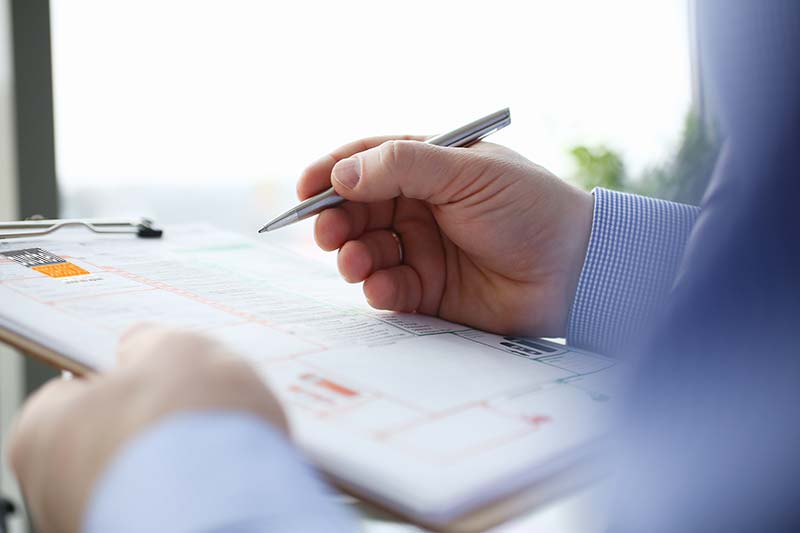 motor claims assessor with clipboard
